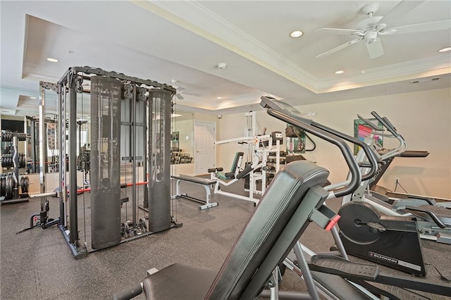 exercise room featuring ceiling fan, a raised ceiling, and ornamental molding