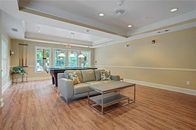 rec room with light hardwood / wood-style floors, a raised ceiling, crown molding, and pool table