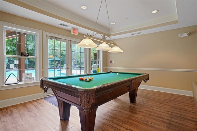 game room with a raised ceiling, french doors, wood-type flooring, and pool table