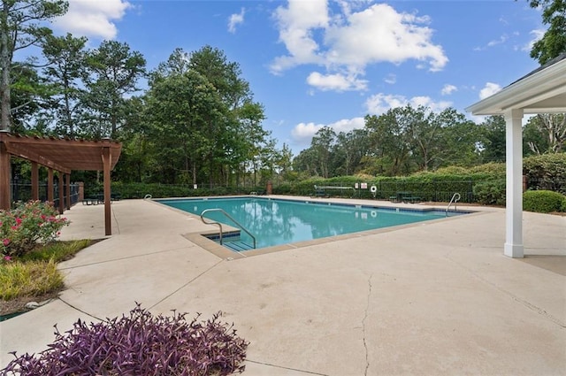 view of swimming pool with a patio and a pergola