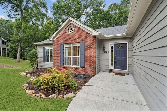 doorway to property featuring a yard