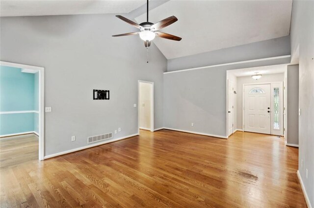 unfurnished living room featuring high vaulted ceiling, light hardwood / wood-style floors, and ceiling fan