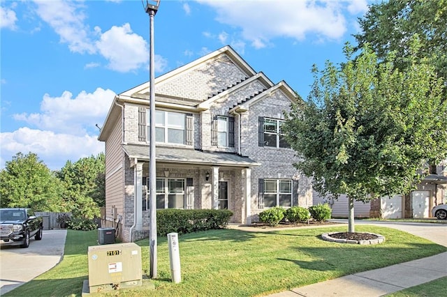 craftsman-style house featuring central AC unit and a front lawn