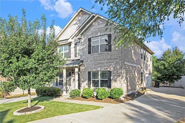 craftsman house featuring a front yard and a garage