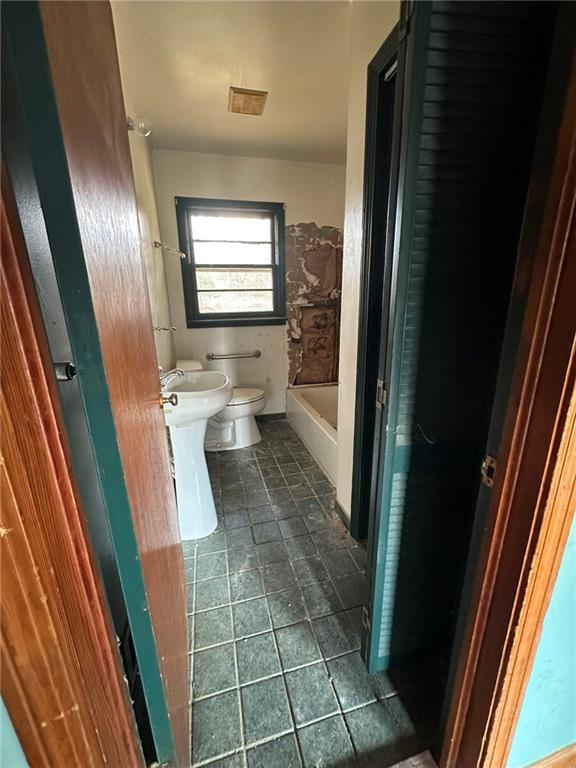 bathroom featuring walk in shower, tile patterned flooring, a bathing tub, and toilet