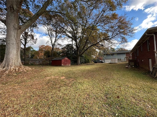 view of yard featuring a storage shed and an outbuilding