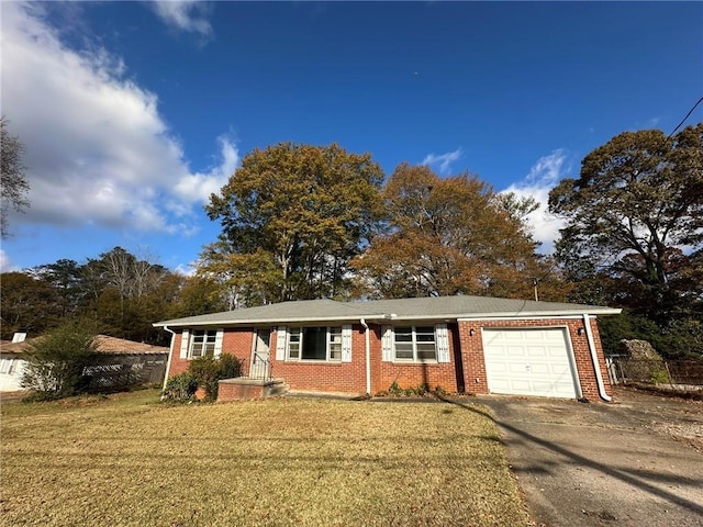 ranch-style home featuring a garage, driveway, brick siding, and a front lawn