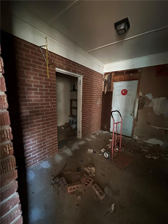 miscellaneous room with brick wall