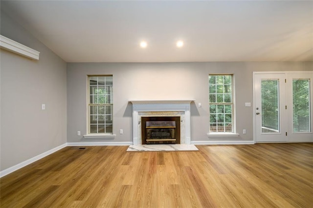 3105 The Trail Rd, Gainesville, GA 30501 - unfurnished living room featuring wood finished floors, a glass covered fireplace, and recessed lighting