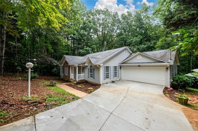 3105 The Trail Rd, Gainesville, GA 30501 - single story home featuring driveway, an attached garage, covered porch, and view of wooded area