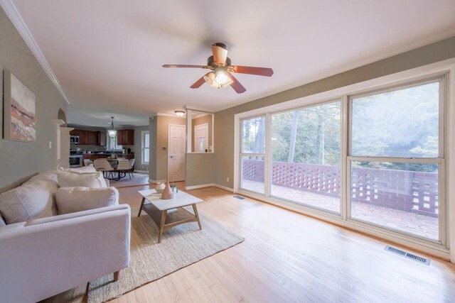 2279 Parkview Cir, College Park, GA 30337 - living room featuring ceiling fan, light wood-style floors, crown molding, and baseboards