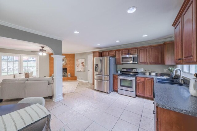 2279 Parkview Cir, College Park, GA 30337 - kitchen with appliances with stainless steel finishes, a sink, ornamental molding, decorative columns, and open floor plan