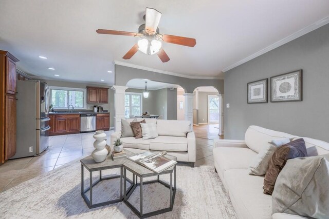 2279 Parkview Cir, College Park, GA 30337 - living room with decorative columns, arched walkways, light tile patterned floors, ornamental molding, and ceiling fan