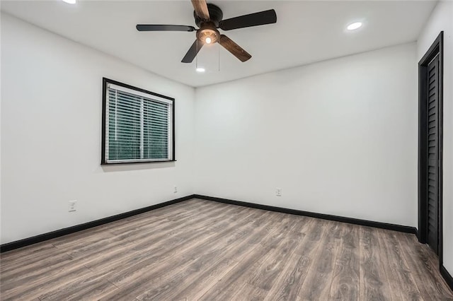 unfurnished room featuring ceiling fan and hardwood / wood-style floors