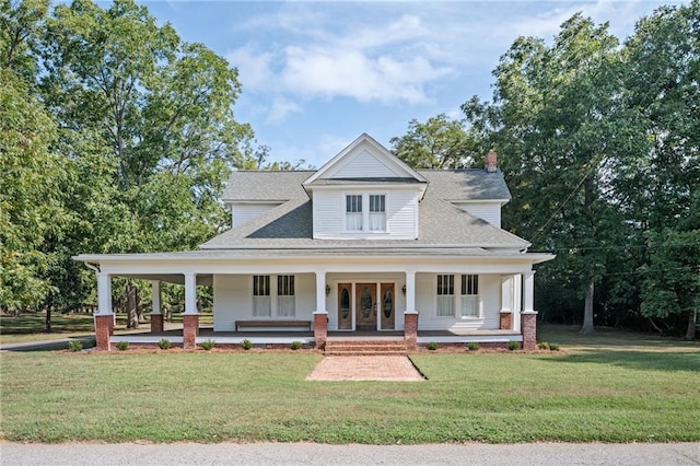 farmhouse-style home with covered porch and a front yard