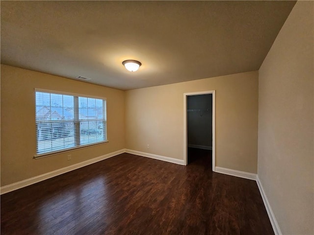 spare room with dark wood-type flooring