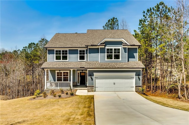 traditional-style house with a front lawn, covered porch, a shingled roof, an attached garage, and driveway