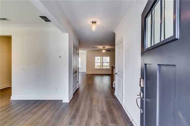 entryway featuring dark wood-type flooring, baseboards, and visible vents