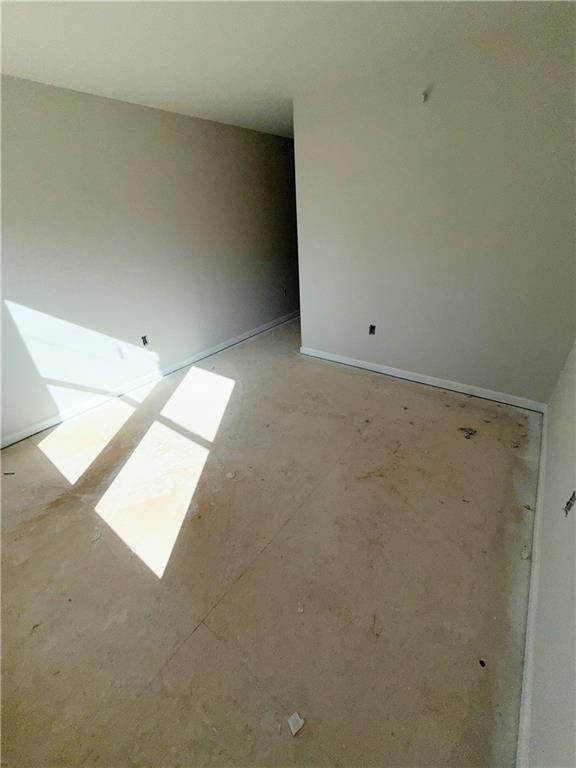 spare room with baseboards
