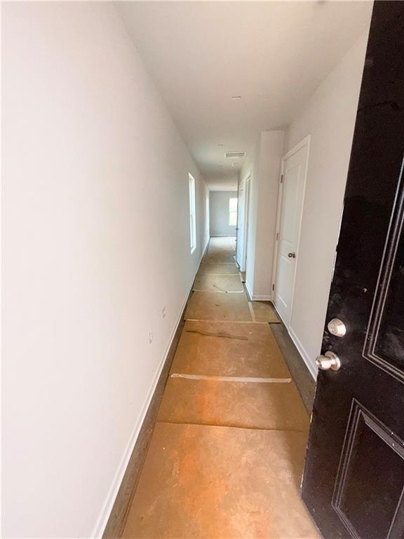 corridor featuring baseboards