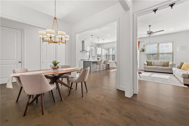 dining area featuring dark wood-type flooring, ceiling fan, and ornamental molding