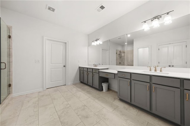 bathroom featuring a shower with door and vanity