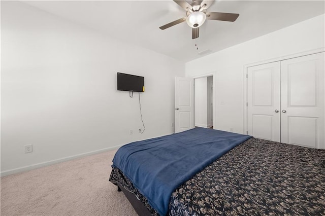 bedroom featuring ceiling fan, a closet, and carpet