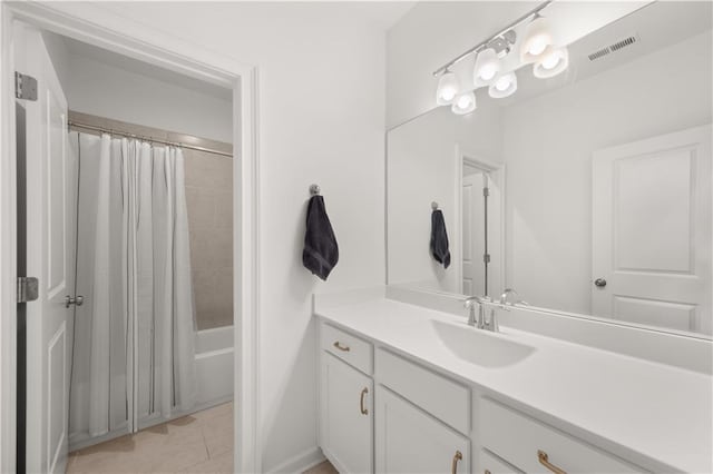 bathroom with tile patterned flooring, vanity, and shower / bath combo