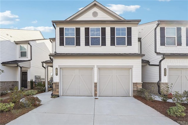 view of front of property featuring stone siding, an attached garage, and concrete driveway