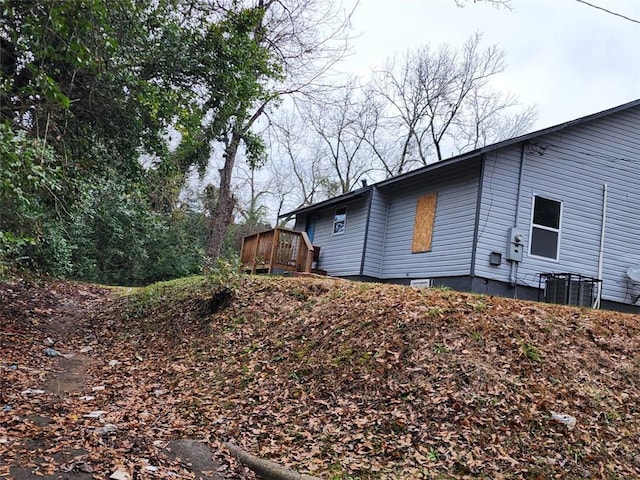 view of side of home with a wooden deck