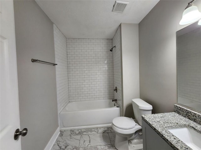 full bathroom with a textured ceiling, vanity, toilet, and tiled shower / bath