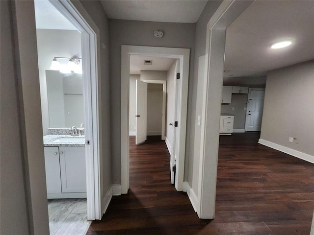 hallway featuring dark hardwood / wood-style floors and sink