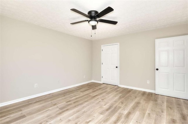 unfurnished bedroom featuring ceiling fan, light hardwood / wood-style floors, and a textured ceiling