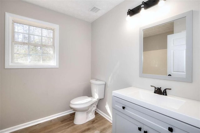 bathroom with vanity, hardwood / wood-style flooring, and toilet