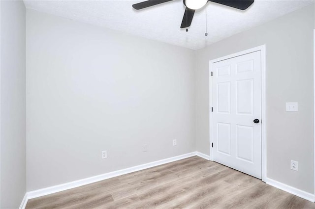 spare room featuring ceiling fan and light wood-type flooring