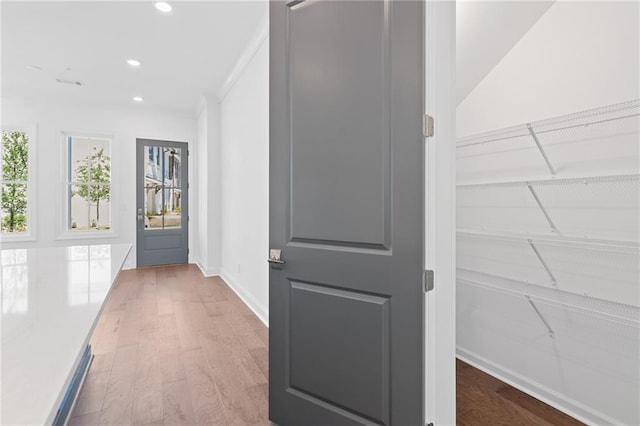 hallway with hardwood / wood-style flooring