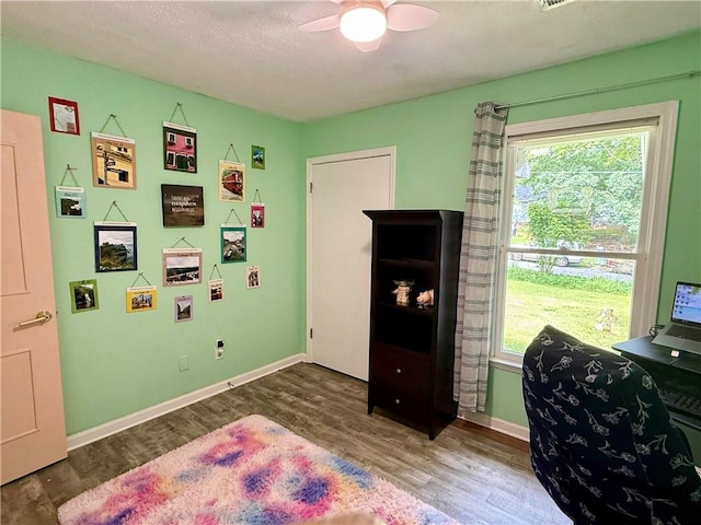 bedroom featuring wood finished floors, baseboards, and a ceiling fan