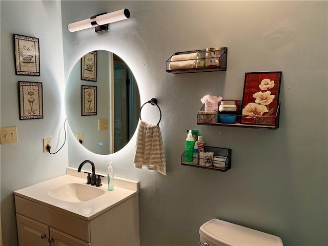 half bath featuring toilet and vanity