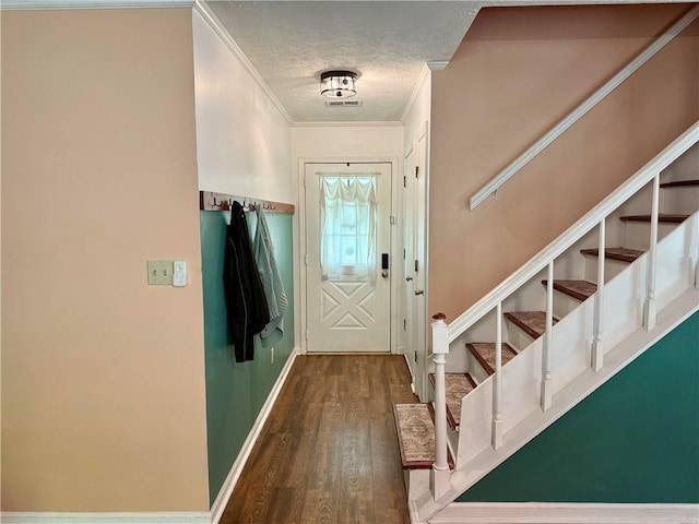 doorway to outside featuring ornamental molding, wood finished floors, a textured ceiling, stairway, and baseboards