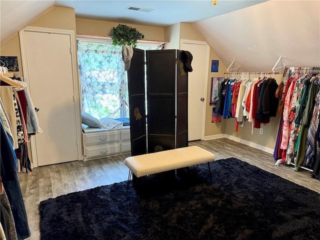 spacious closet featuring wood finished floors and lofted ceiling