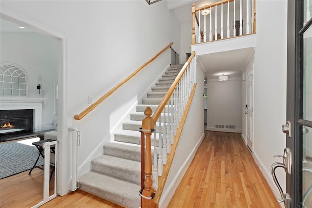 1217 Club Walk Dr NE, Brookhaven, GA 30319 - stairway featuring wood finished floors, a high end fireplace, and baseboards
