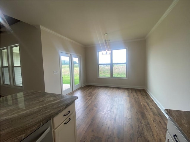 216 Montview Dr, Jefferson, GA 30549 - unfurnished dining area featuring dark wood-type flooring, plenty of natural light, a chandelier, baseboards, and ornamental molding