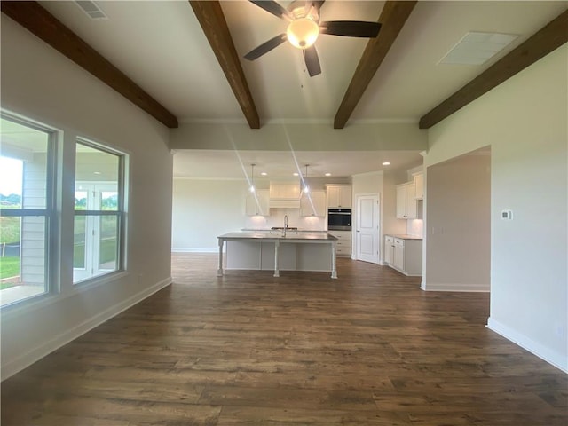 216 Montview Dr, Jefferson, GA 30549 - kitchen featuring stainless steel oven, beam ceiling, white cabinets, dark wood-style floors, and baseboards