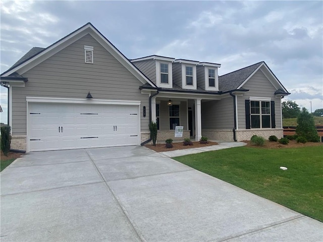 216 Montview Dr, Jefferson, GA 30549 - view of front of home with concrete driveway, covered porch, a front lawn, an attached garage, and stone siding
