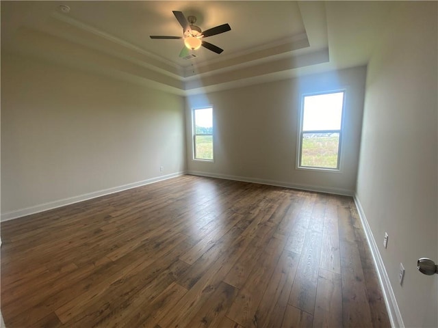 216 Montview Dr, Jefferson, GA 30549 - unfurnished room featuring a tray ceiling, dark wood finished floors, ceiling fan, baseboards, and ornamental molding
