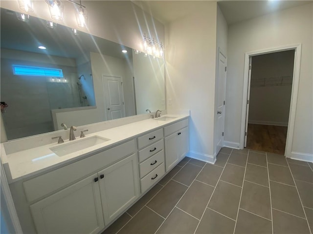 216 Montview Dr, Jefferson, GA 30549 - bathroom with a walk in shower, double vanity, baseboards, and tile patterned floors