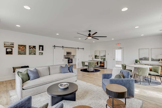 216 Montview Dr, Jefferson, GA 30549 - living area featuring a barn door, light wood finished floors, recessed lighting, baseboards, and a ceiling fan