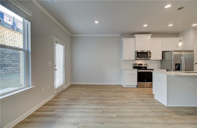 8147 Tiger Way, Riverdale, GA 30296 - kitchen featuring appliances with stainless steel finishes, ornamental molding, white cabinetry, light countertops, and light wood-type flooring