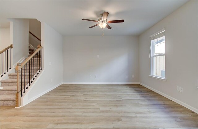 8147 Tiger Way, Riverdale, GA 30296 - spare room with a ceiling fan, light wood-style flooring, stairs, and baseboards