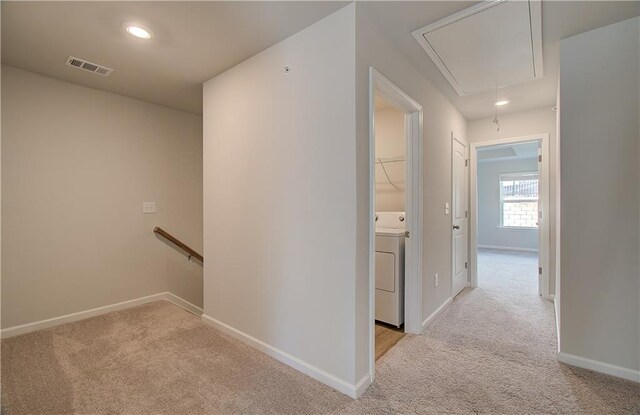 8147 Tiger Way, Riverdale, GA 30296 - hallway with attic access, washer / dryer, light colored carpet, an upstairs landing, and baseboards